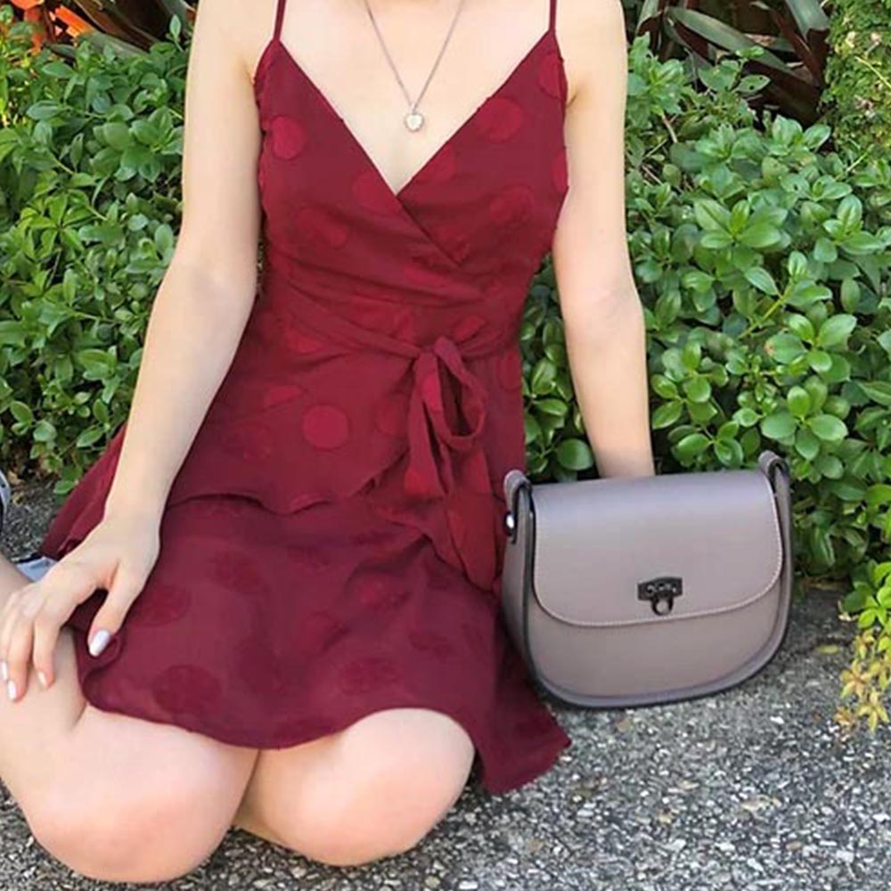 lady in a red dress with a grey leather handbag