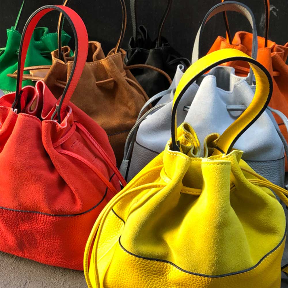 various yellow, red, blue, brown and green leather handbags