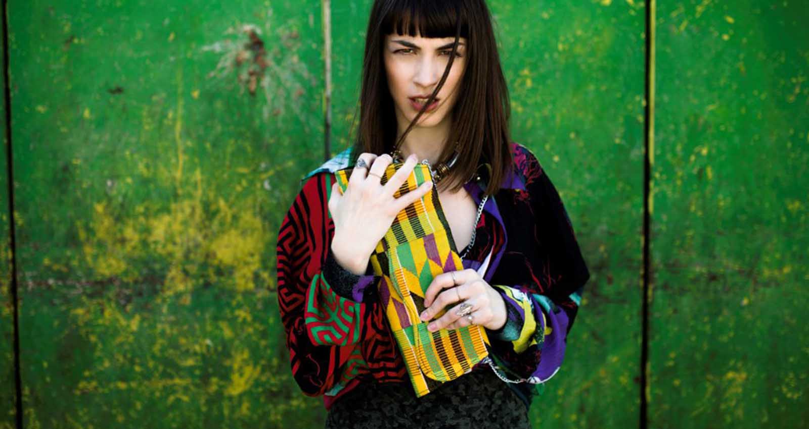 Sorella Handbags lady holding a colorful clutch bag