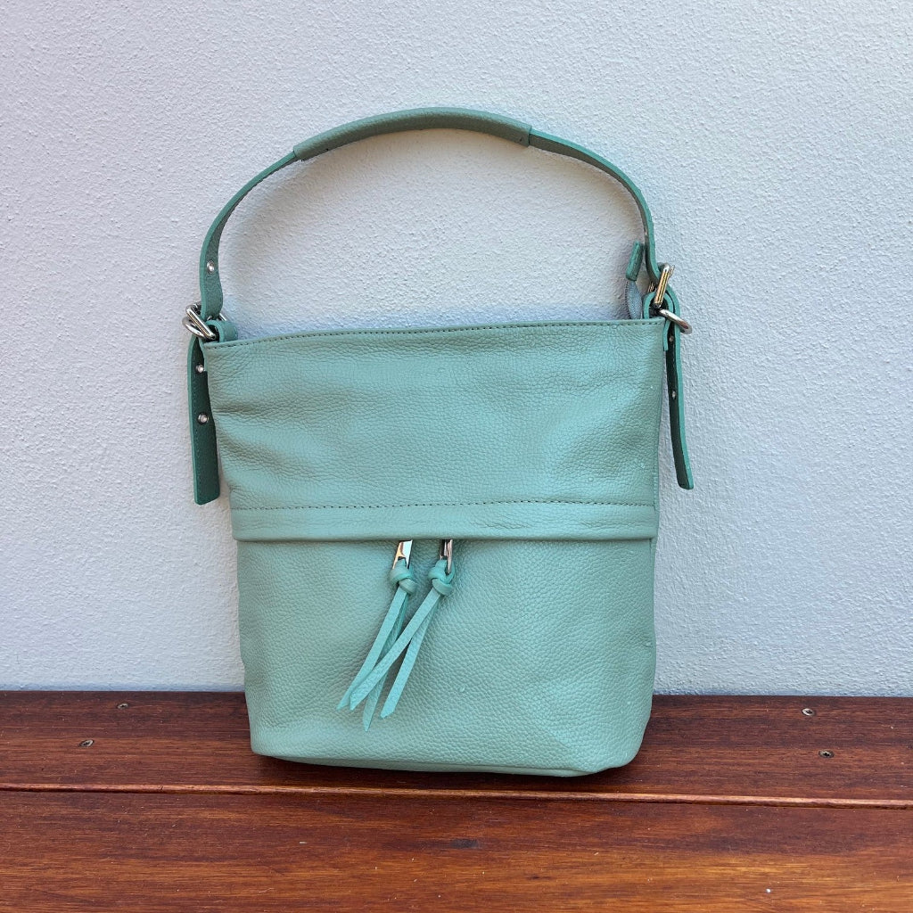 Tilly bag in sage green against a wall