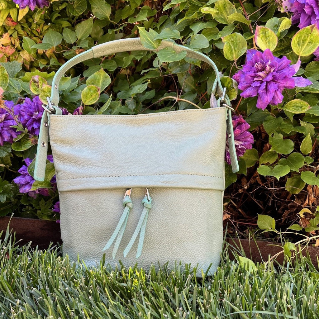 Tilly bag in sage green in a garden