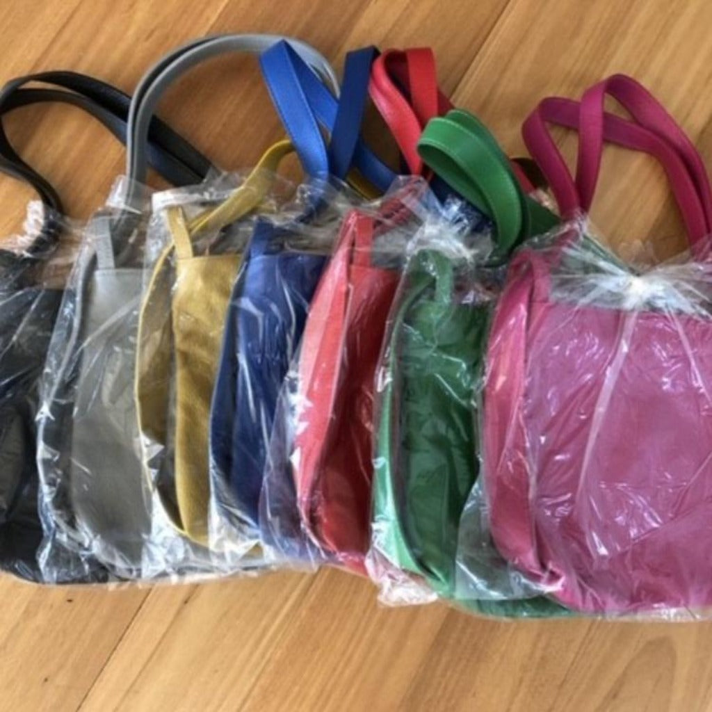 The small shoulder bag and backpack shown in seven different colours