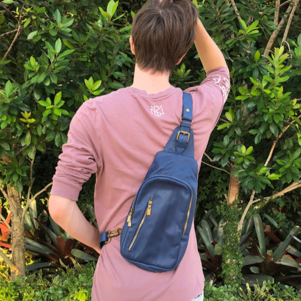 man with the Samuel backpack in blue over his right shoulder