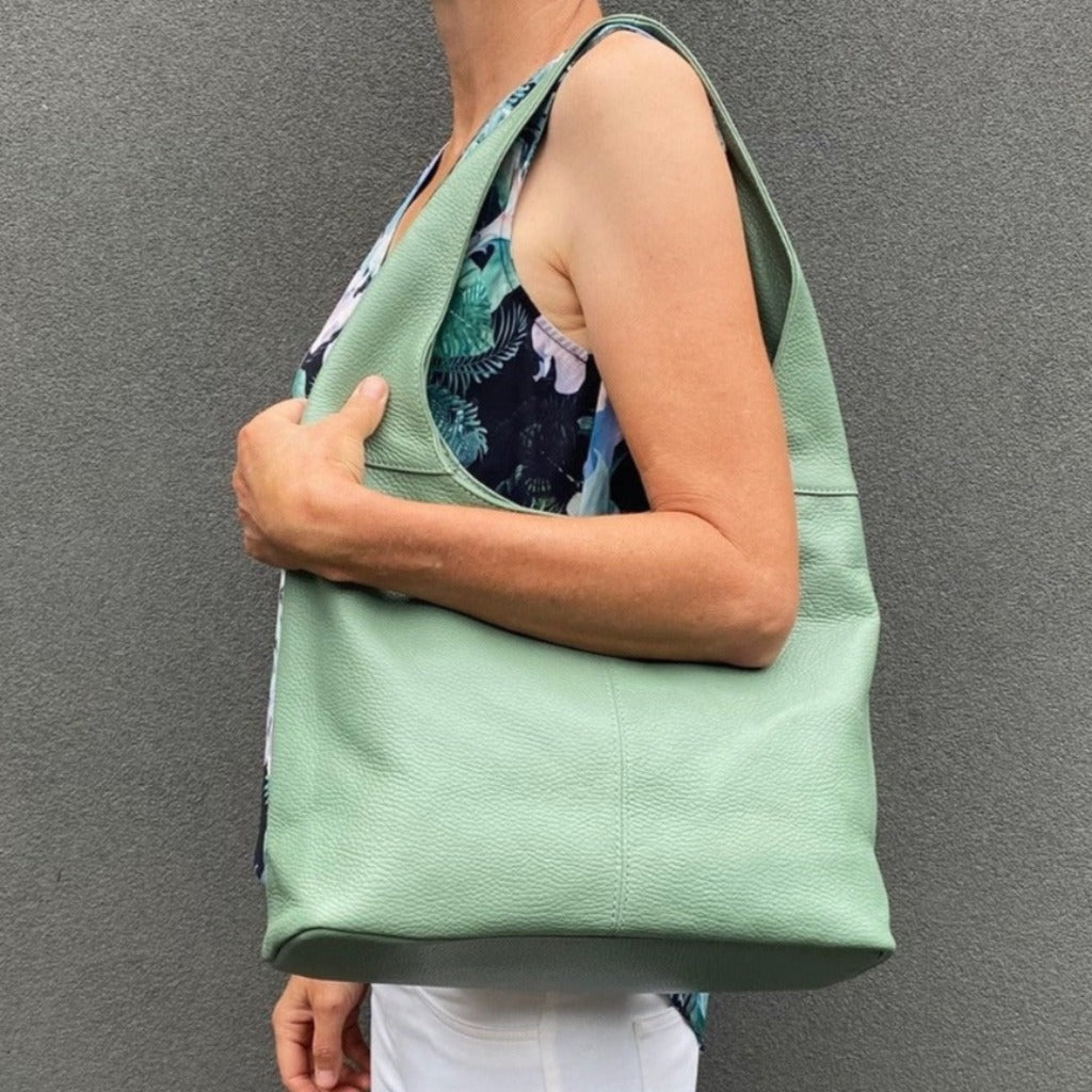 Woman with the sage (darkseagreen) Coco bag on her shoulder