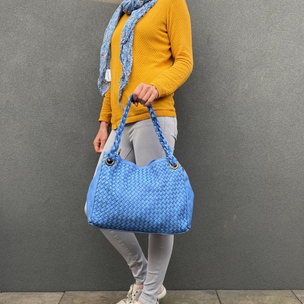Woman holding the Izzy bag in blue