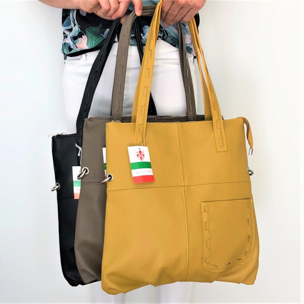 Sorella Handbags woman holding three of the Kate bags