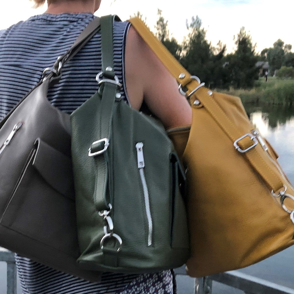 Woman holding three Phillipa bags