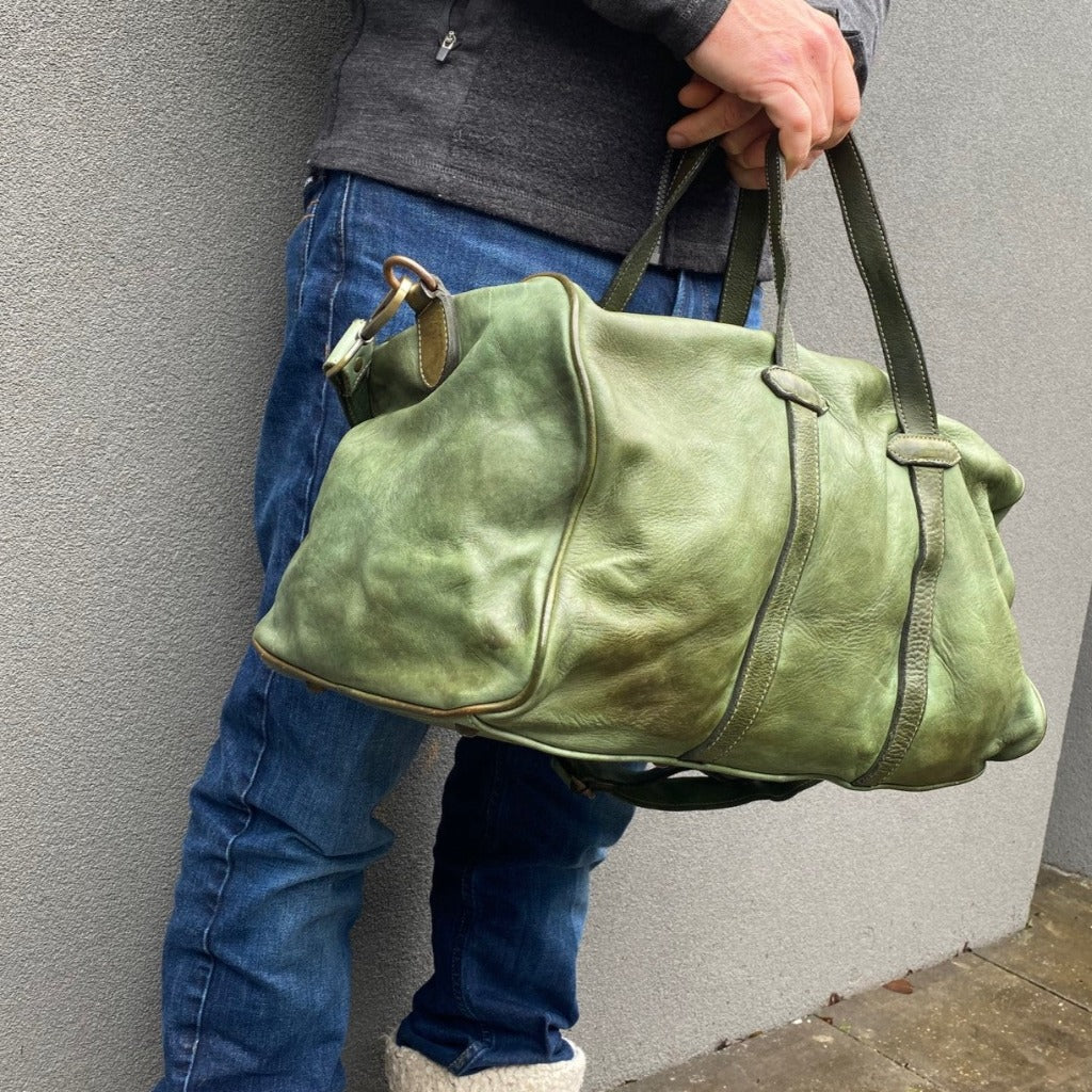 Man holding the green Raymond bag