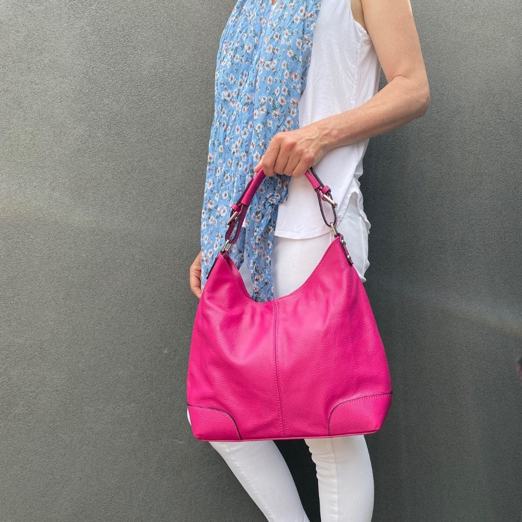 Woman holding the Sarah bag in hot pink