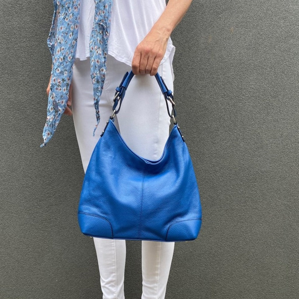 Woman holding the Sarah bag in royal blue