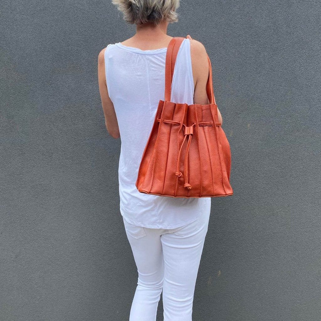 Sorella Handbags woman with orange Susie bag over her shoulder