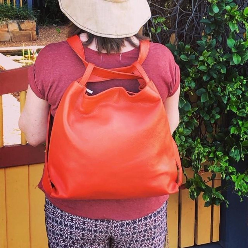 woman wearing the burnt orange backpack on her back