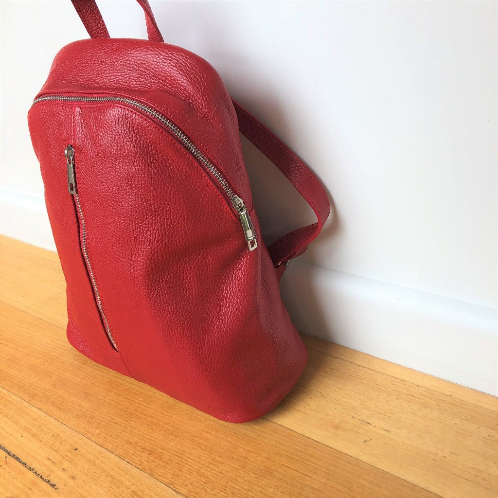 Side view of the Avita backpack in red