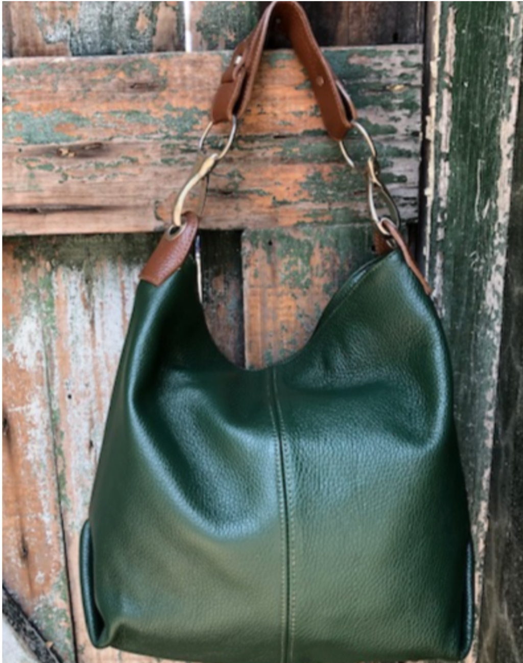 he Daisy bag in green with a brown handle
