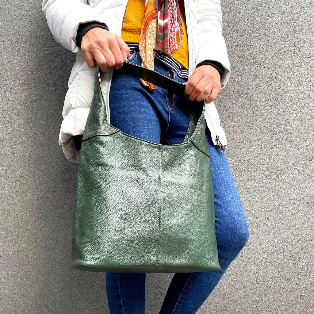 Woman holding the Coco bag in forest green