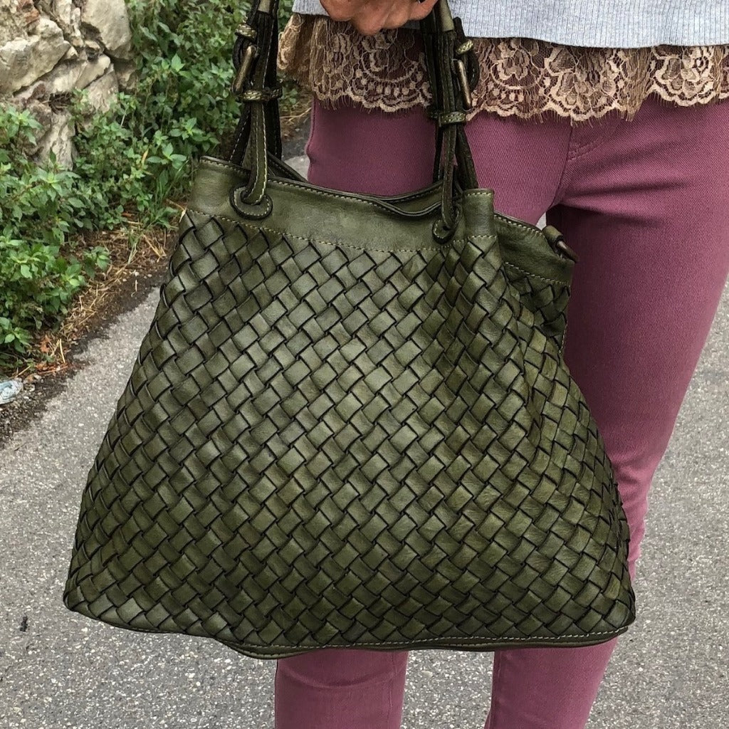 Woman holding a Diamonte bag in olive green