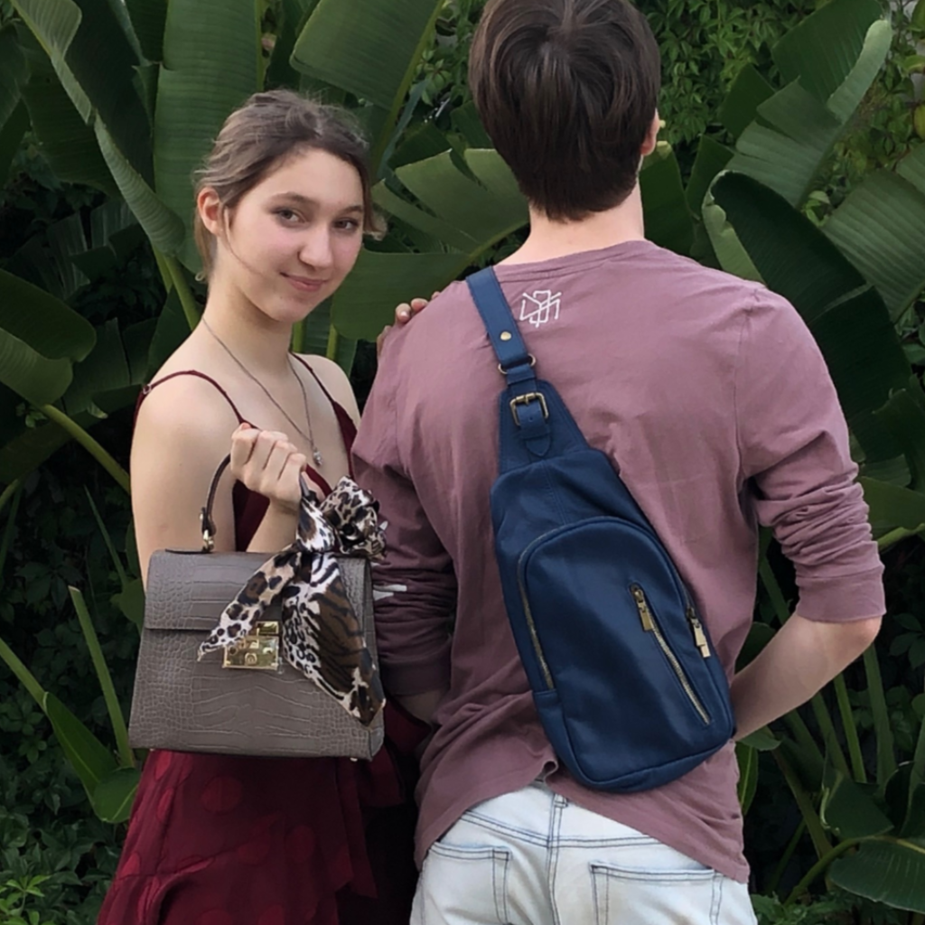 Photo of a couple with the man displaying the Samuel bag over his shoulder in blue