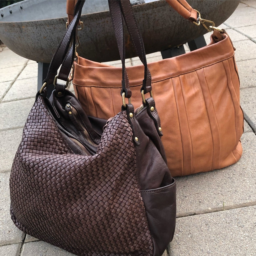 Kierra bag in natural setting near a fire pit