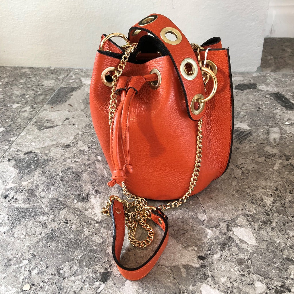Photo of the orange Lucy tote with chain