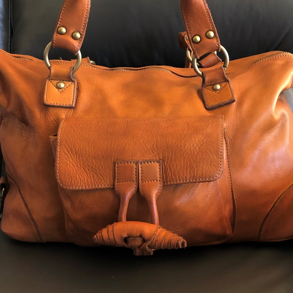 Tori vintage bag in natural on a couch