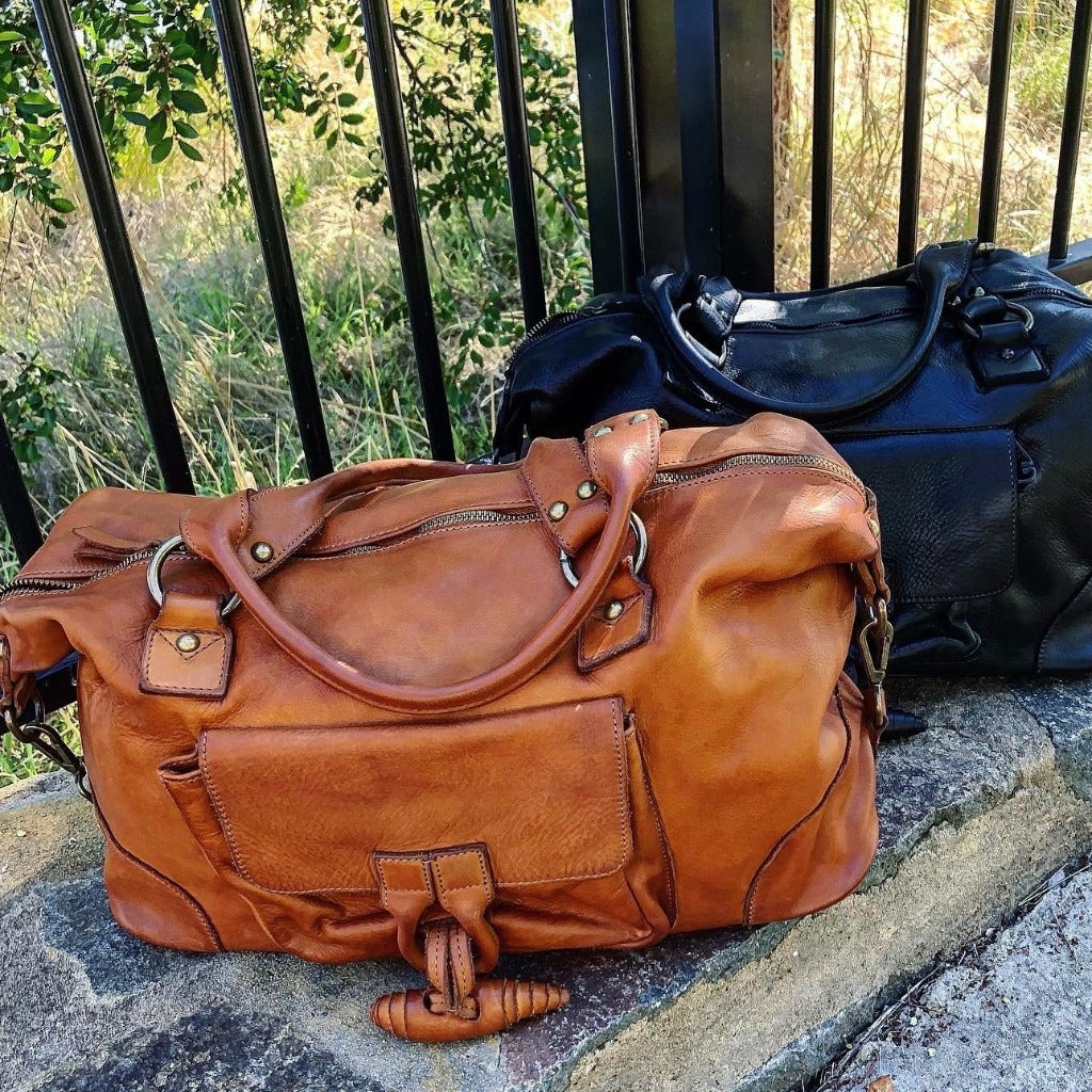 Tori vintage bags outside near a fence