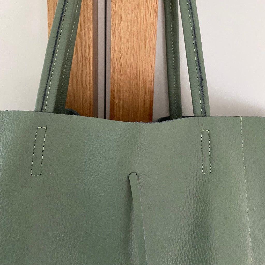 Close up view of the Muzi bag in sage green
