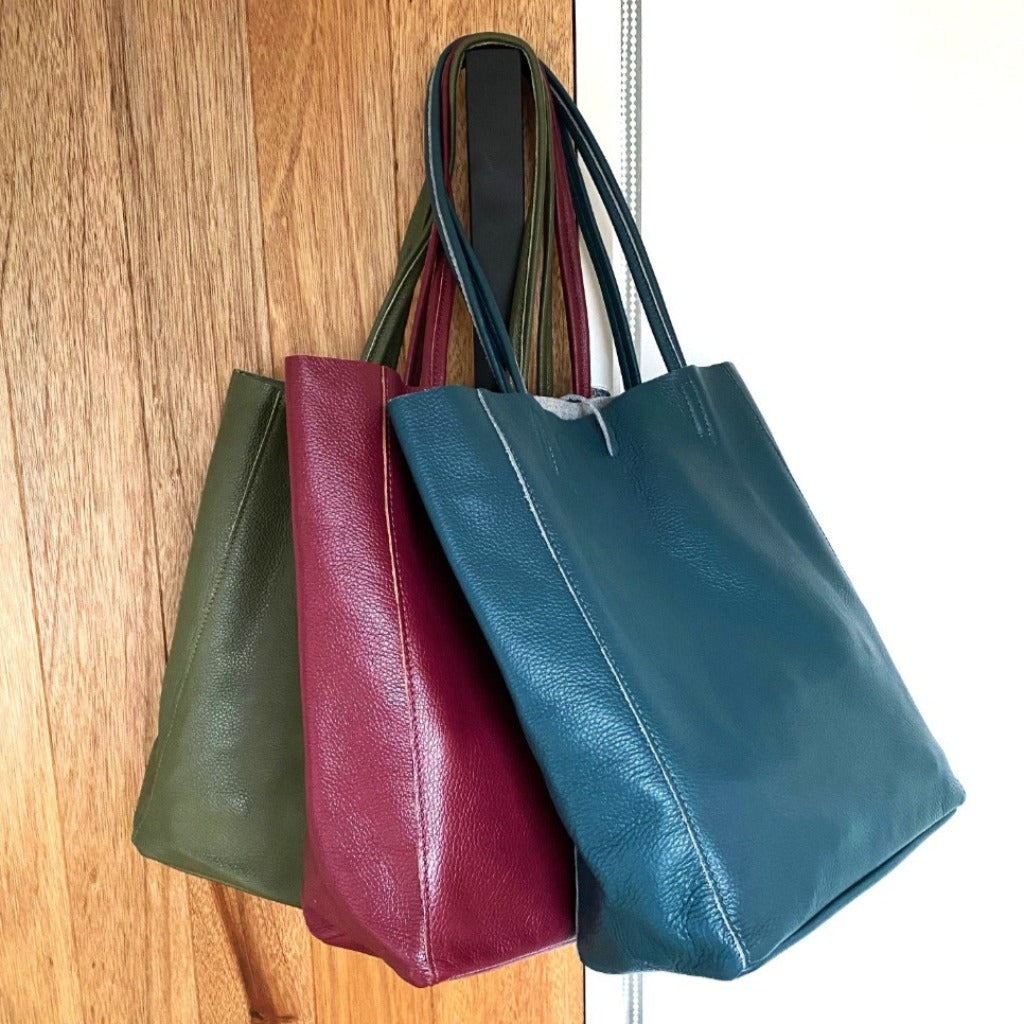 Muzi bag in (left to right) olive, burgundy and teal