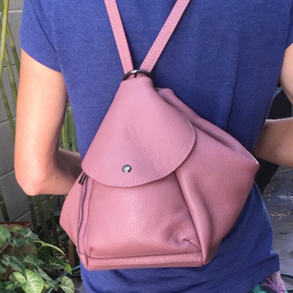A woman wearing the Tanya backpack in musty pink