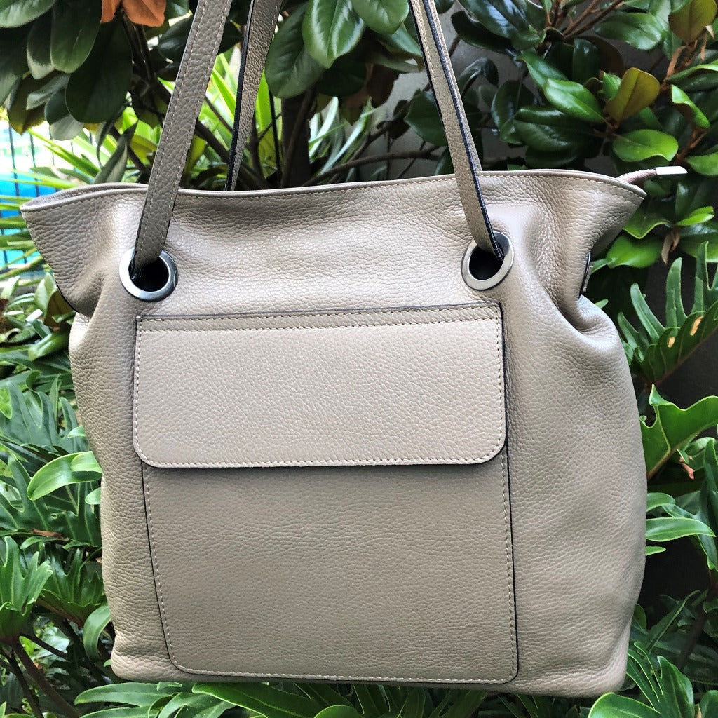 Photo of the Priscilla bag in taupe hanging in a tree