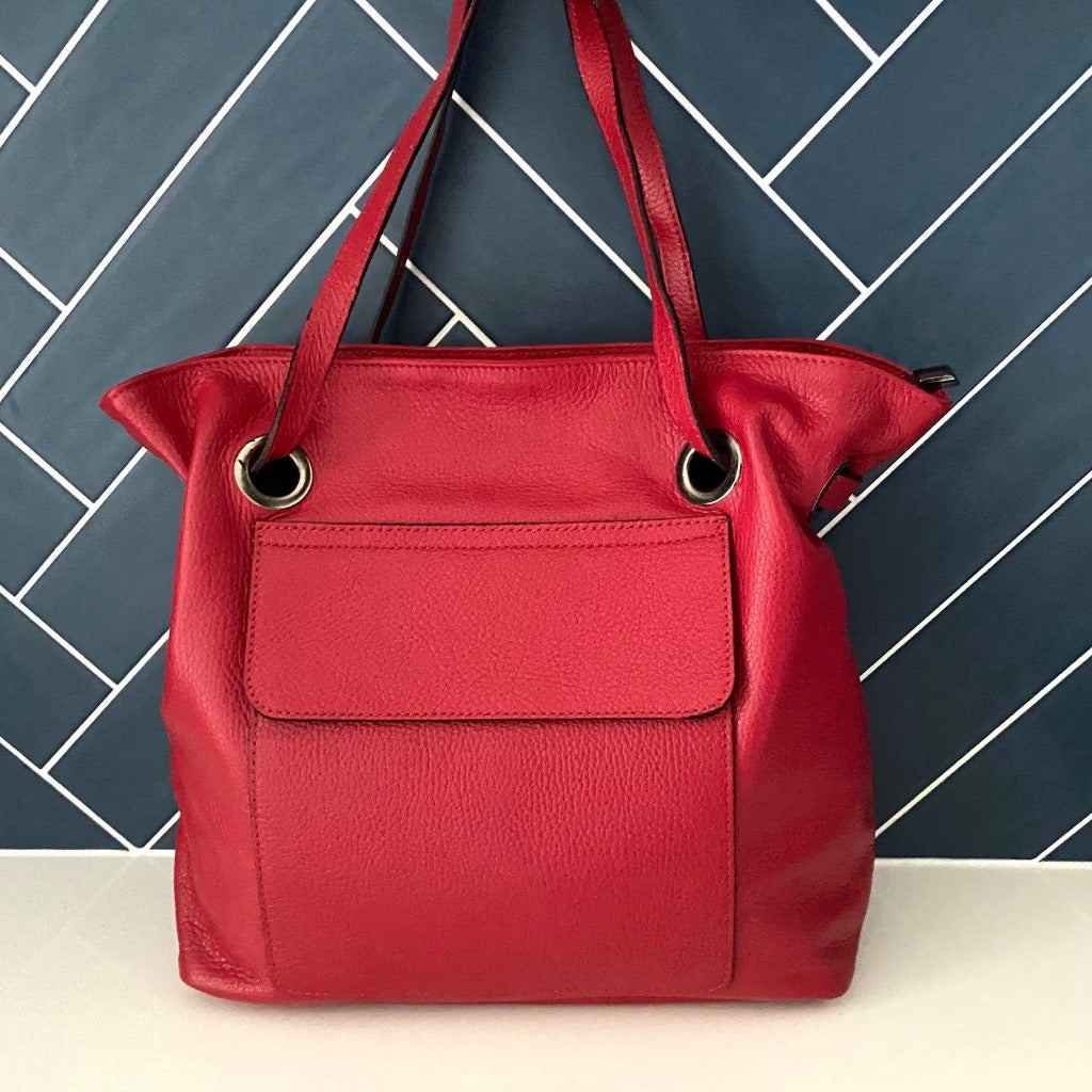 Priscilla in red on a bench