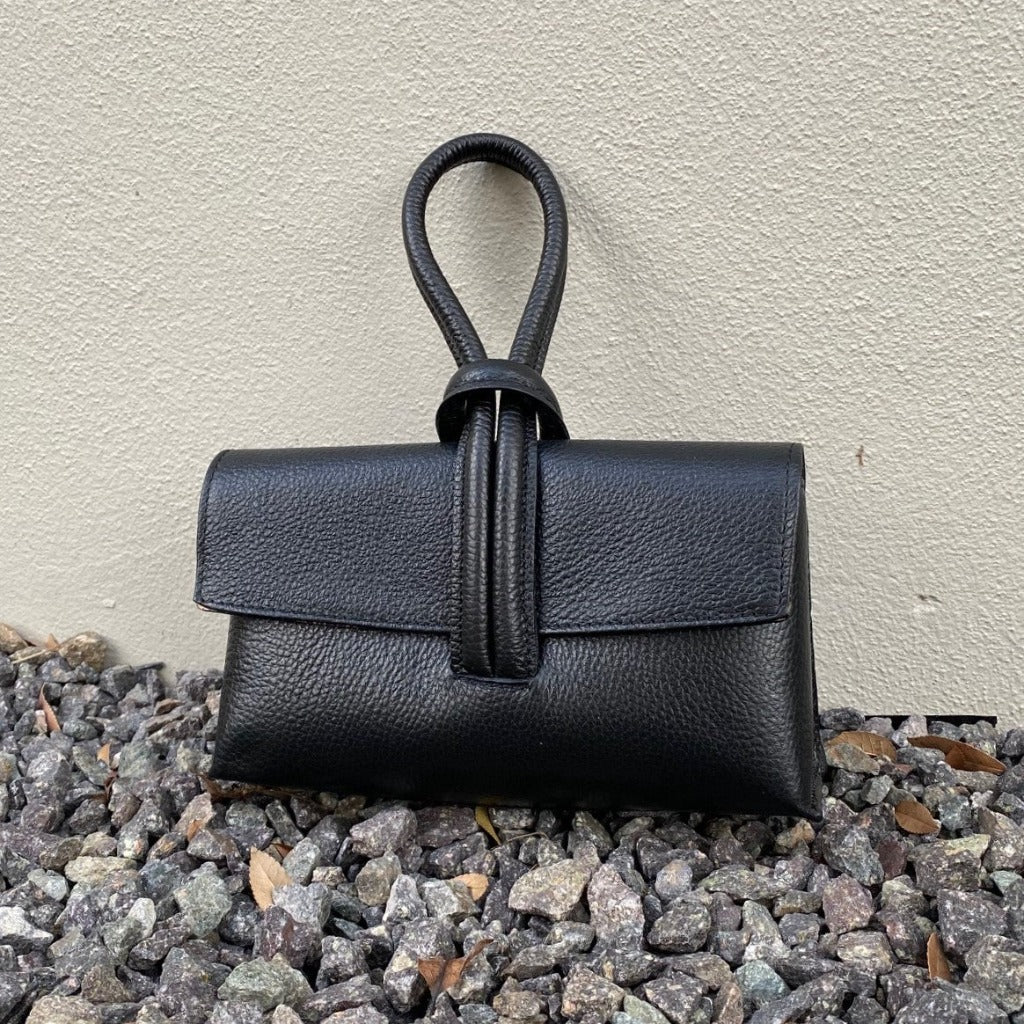 Rachelle clutch in black taken outside