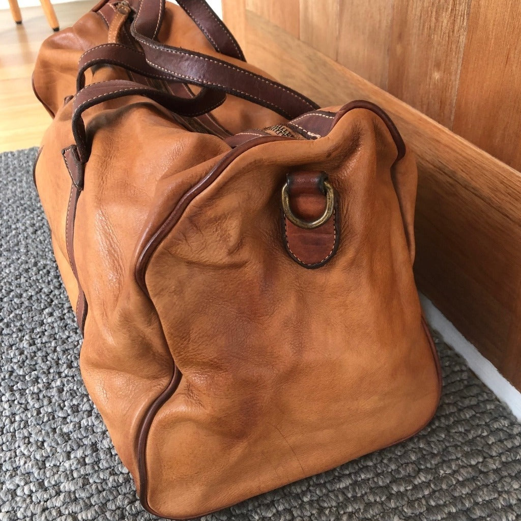 Raymond bag in sienna sitting on the floor