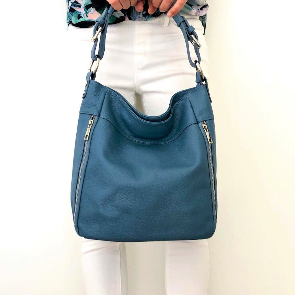 Woman holding the Samantha bag in denim