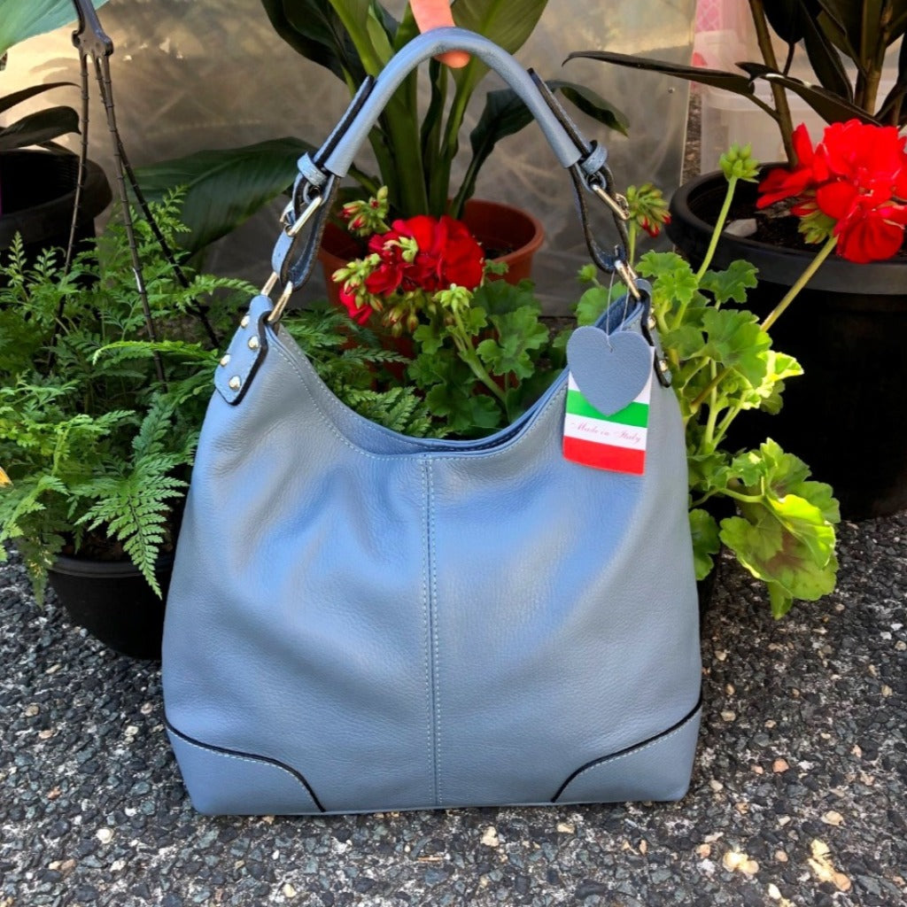 Denim blue Sarah bag in a garden