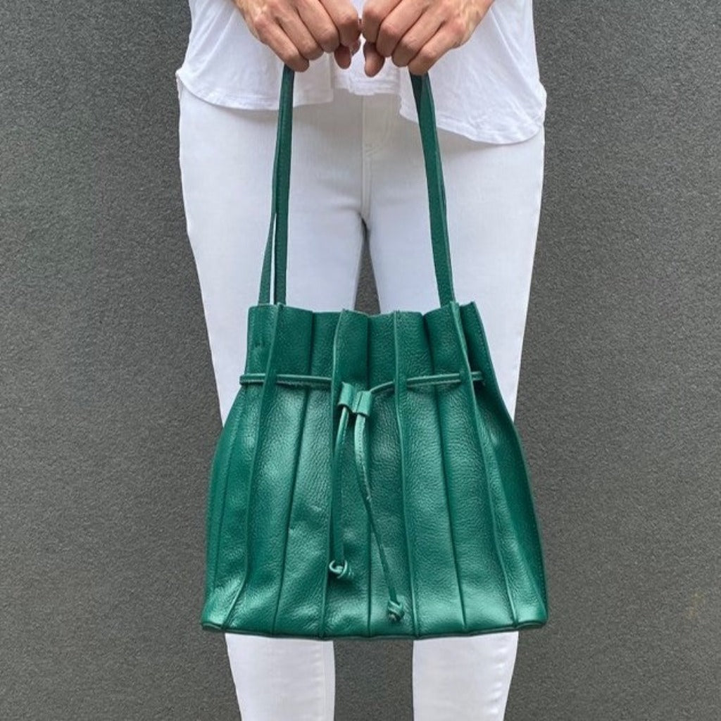 Woman holding the Susie bag in seagreen